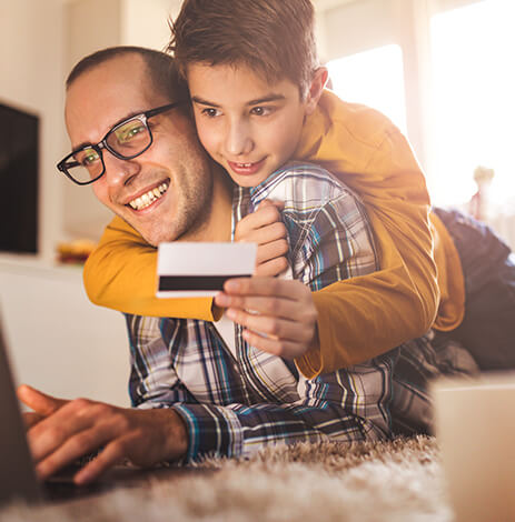 father and son paying a bill online together