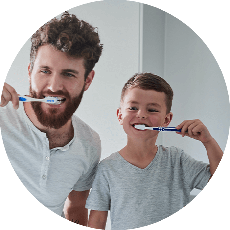 dad and son brushing teeth